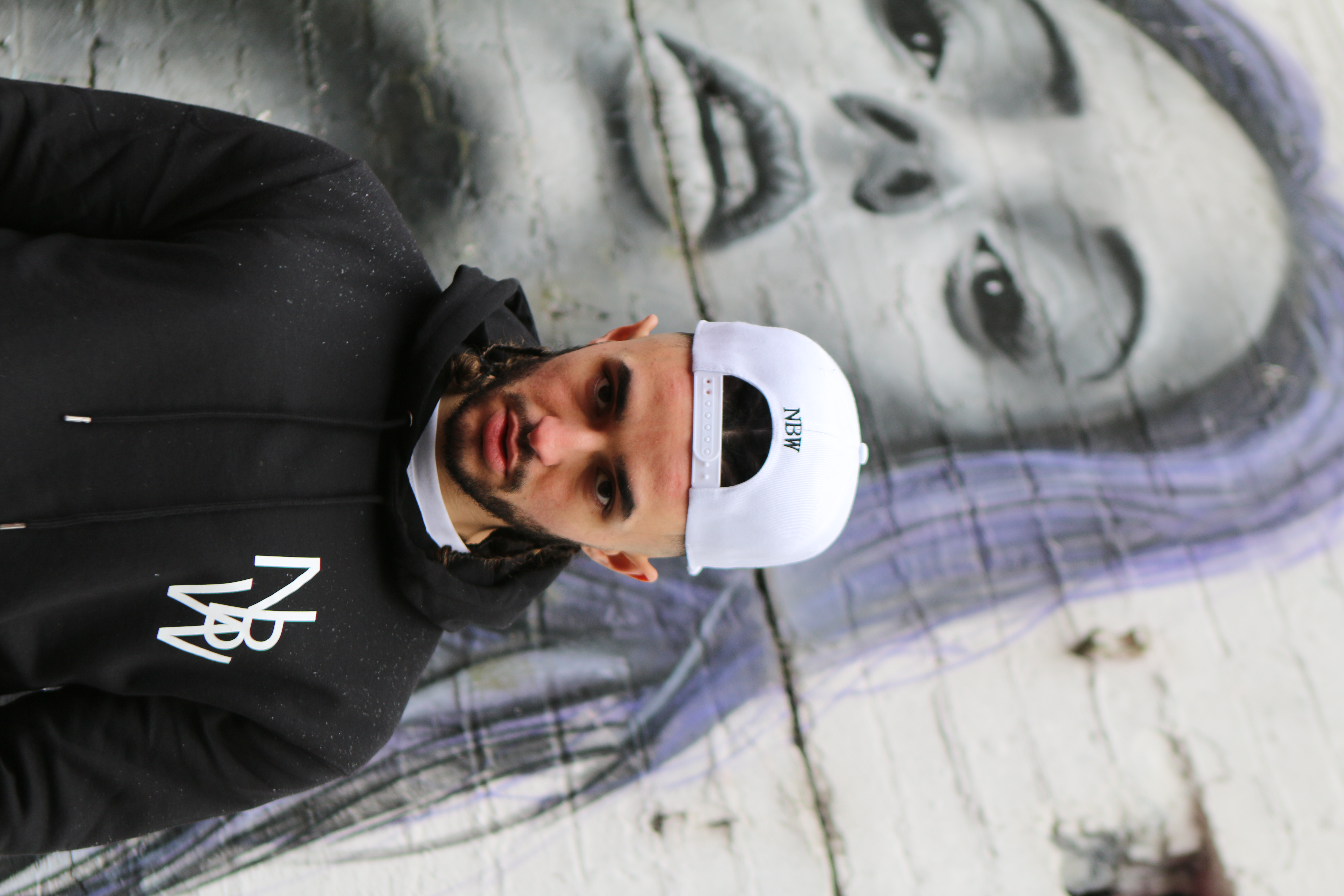 Model wearing a NaijaBoi Wear embroidered snapback cap in the UK