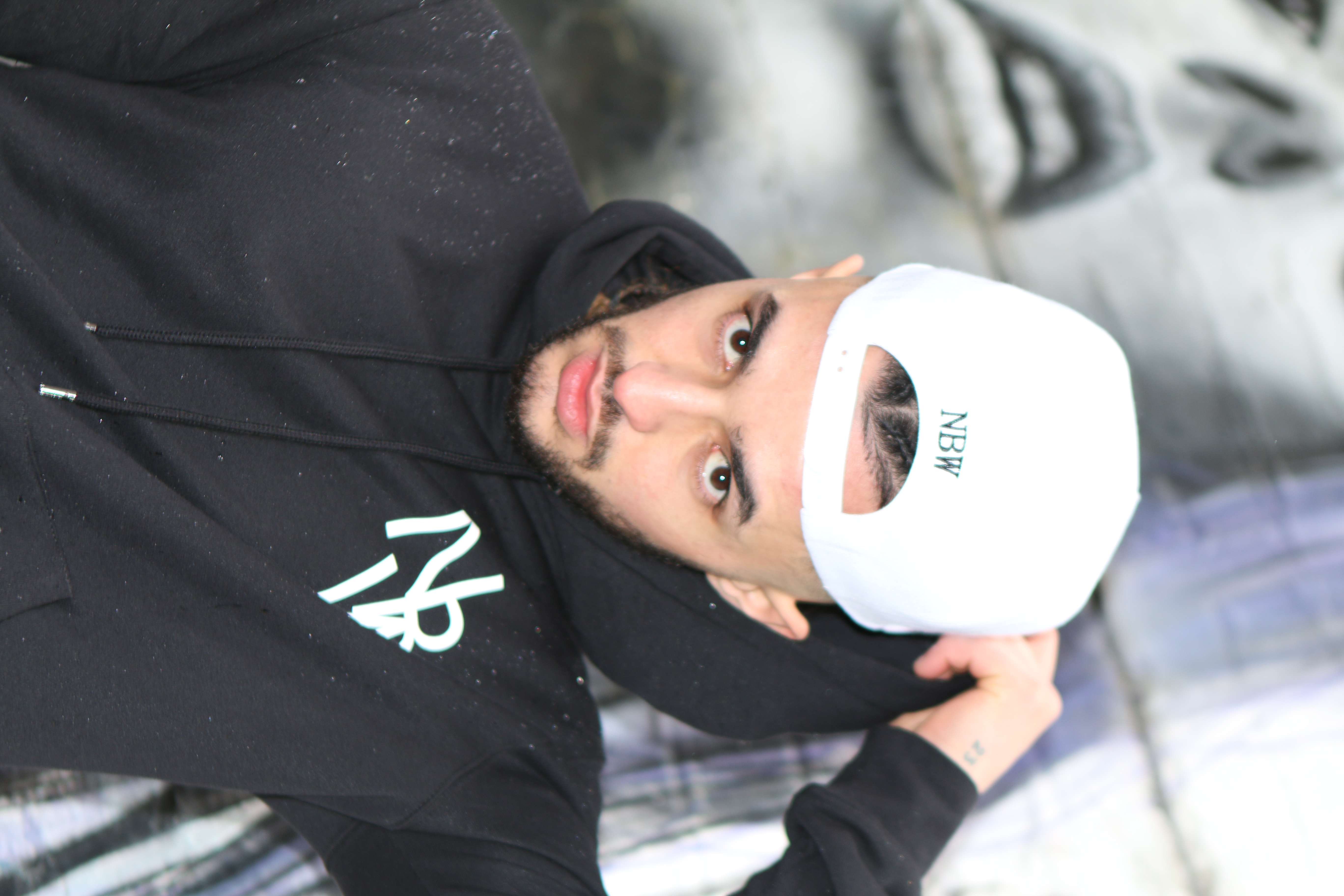Close-up of the NaijaBoi Wear gold-thread embroidered crest on a snapback